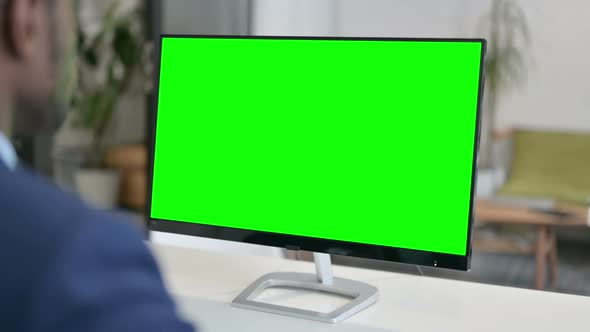 Businessman Working on Desktop with Green Chroma Key Screen