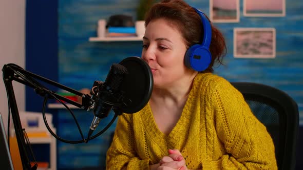 Woman Recording Video on Camera in Home Studio