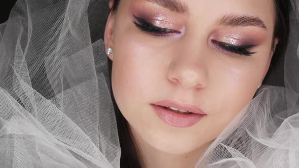 Portrait of a Beautiful Model in Wedding Fashion Style in a White Veil Posing with Stylish Evening