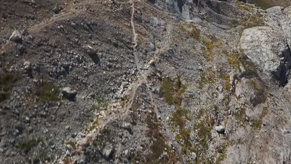 Droneshot going from below to the top of the mountain