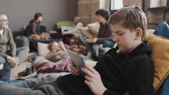 Tween Boy Using Tablet in Refuge