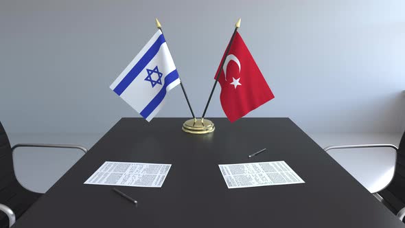 Flags of Israel and Turkey and Papers on the Table