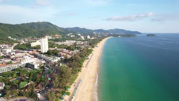 Aerial Drone shot of tropical sea Beautiful waves crashing on sandy shores at karon beach in phuket