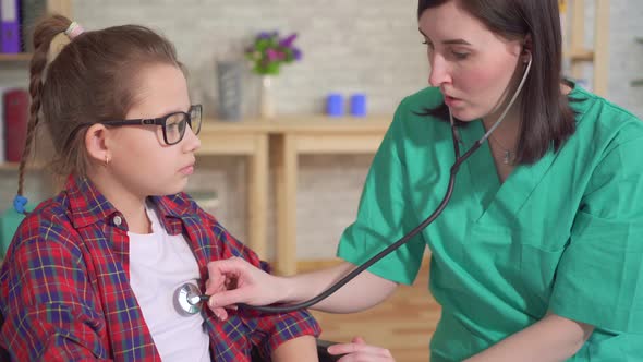 Doctor Therapist and the Child in the Wheelchair the Use of a Stethoscope