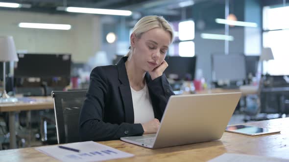 Tired Businesswoman Having Quick Nap While Working in Office