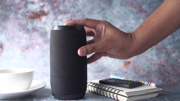 Man's Hand Using Smart Speaker Table