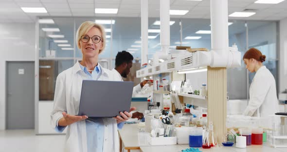 Portrait of Female Researcher Laptop Talking on Camera About Research in Chemistry Lab