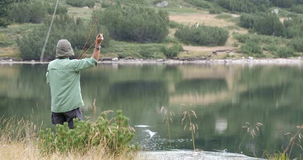 Fly Fishing On Mountain Lake In Pirin In Bulgaria