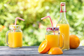 Orange juice and sliced oranges on a wooden table - PhotoDune Item for Sale