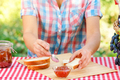 Woman in plaid shirt spreads jam on bread - PhotoDune Item for Sale