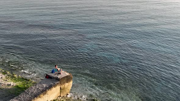 A fisherman catches fish in the sea aerial view 4 K