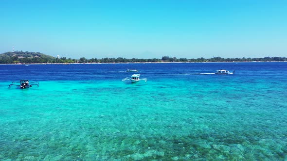 Wide angle flying abstract view of a sunshine white sandy paradise beach and aqua blue ocean 