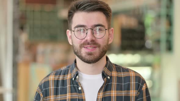 Portrait of Cheerful Young Man Talking on Video Call