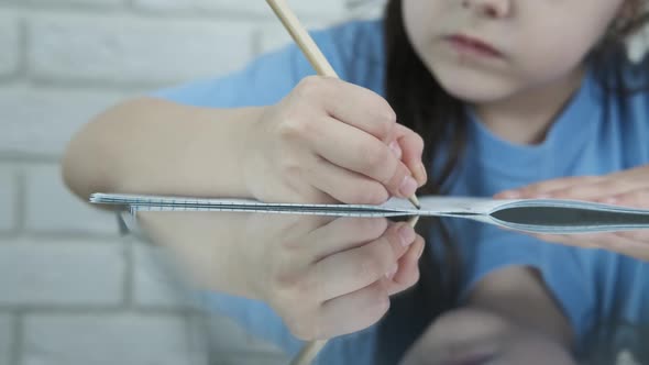 The child writes in a notebook. 