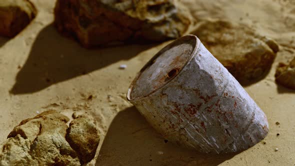 Rusty Metal Oil Barrel on Sand Beach