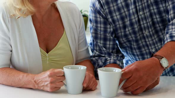 Couple interacting while having a cup of coffee