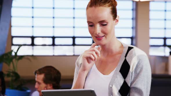 Smiling woman using digital tablet