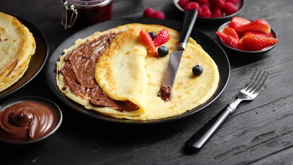 Delicious Chocolate Homemade Pancakes on Black Ceramic Plate