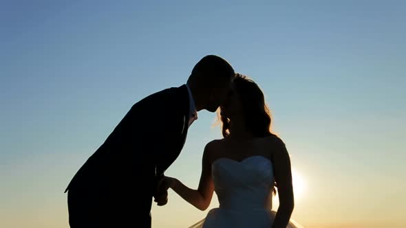 Beautiful Wedding Couple on the Sunset in the Mountains