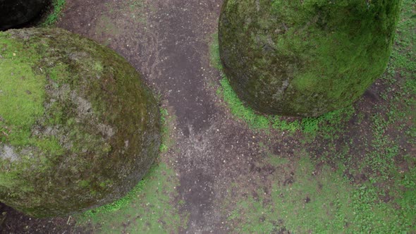 slow drone overflight rocks in the form of huge eggs overgrown with moss Europe park near Vilnius Li