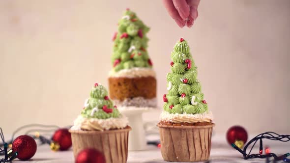 Decorating Christmas tree cupcake with coconut flakes