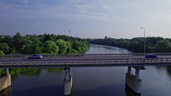 Driving Many Cars on Bridge Round Green Grass and Trees