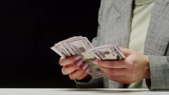 Counting American Fifty Dollar Banknotes on Black Background