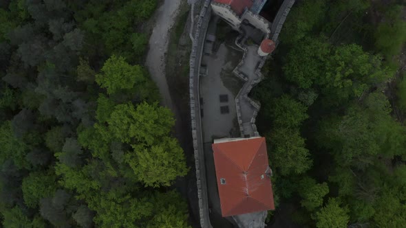 Overhead aerial view of Kokořín castle in Czechia surrounded by trees.