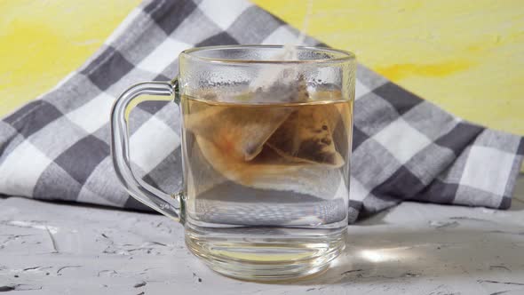 Put The Tea Bag In A Glass Bowl of Hot Water Close Up
