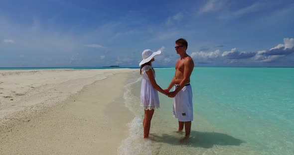 Fun lady and man on romantic honeymoon have fun on beach on paradise white sand background 