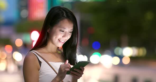 Asian woman use of mobile phone at night