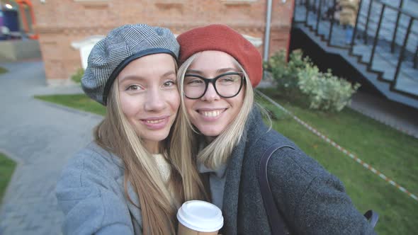 Friendship and Relationship Concept. Two Young Woman Fiends Taking Pictures Self Portrait