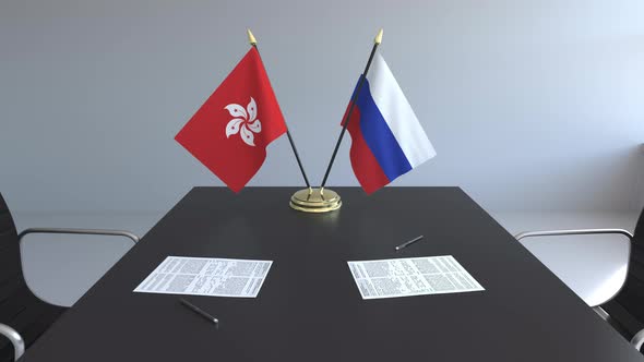 Flags of Hong Kong and Russia on the Table alt