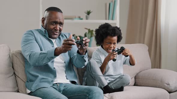 Happy African American Family Dad and Daughter Have Fun Together Father Playing Video Game on