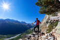 Hiker takes a rest observing a mountain panorama. - PhotoDune Item for Sale