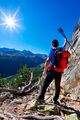 Hiker takes a rest observing a mountain panorama. - PhotoDune Item for Sale