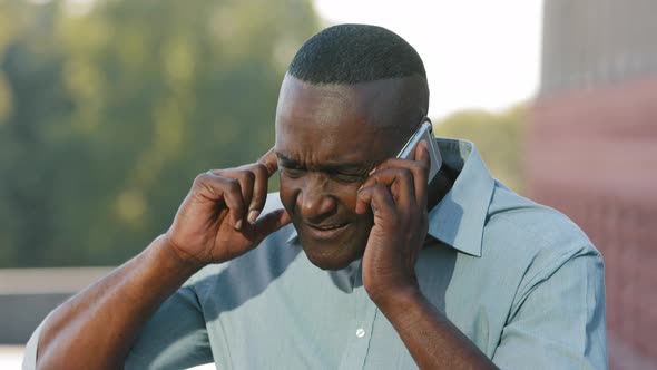 Serious Angry Black Adult Mature African American Man Sitting Outdoors Holding Smartphone