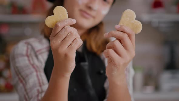 Selective Focus of Grandchild Holding Cookie Dough with Heart Shape in Hands