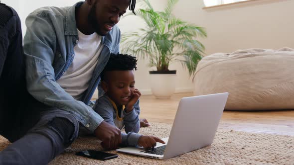 Father and son using technology together at home