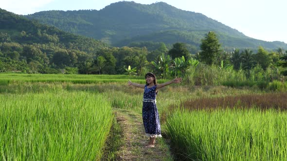 Cute Little Girl Jumping In Rice Field