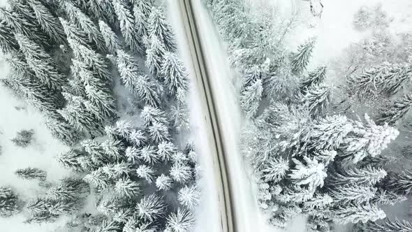 Aerial drone view of road in idyllic winter landscape.