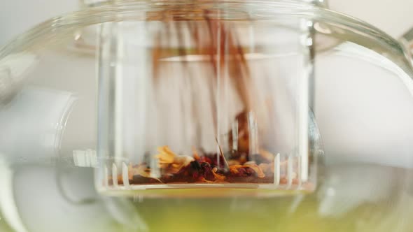 Putting Dry Tea Leaves Into Teapot Closeup