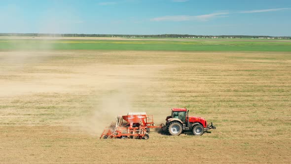 Elevated View Tractor With Seed Drill Machine Sowing The Seeds For Crops In Spring Season