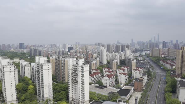 aerial pan shot of an empty street with Pudong building