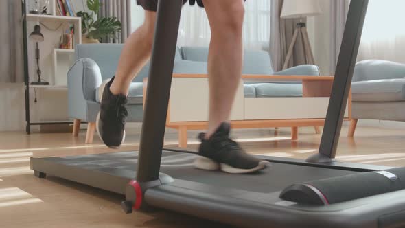 Legs Of Man Running On A Treadmill At Home