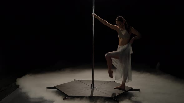 Girl Dancing on Pole Dance . Black Smoke Background