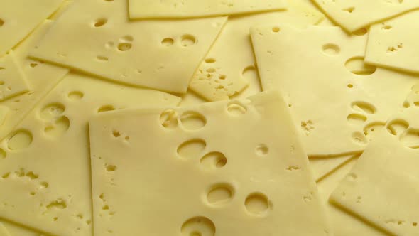 Passing Cheese Slices With Holes Closeup