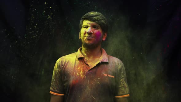 Young adult man celebrating holi with colors. holi is a festival of India. It is festival of colors