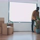 Multi ethnic young couple opening boxes in new home - VideoHive Item for Sale