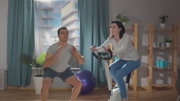 Athletic Couple Sports in Their Living Room at Home